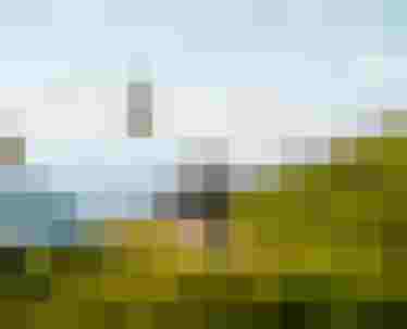 Zwei Mountainbiker auf Almweg mit Seilbahn im Hintergrund